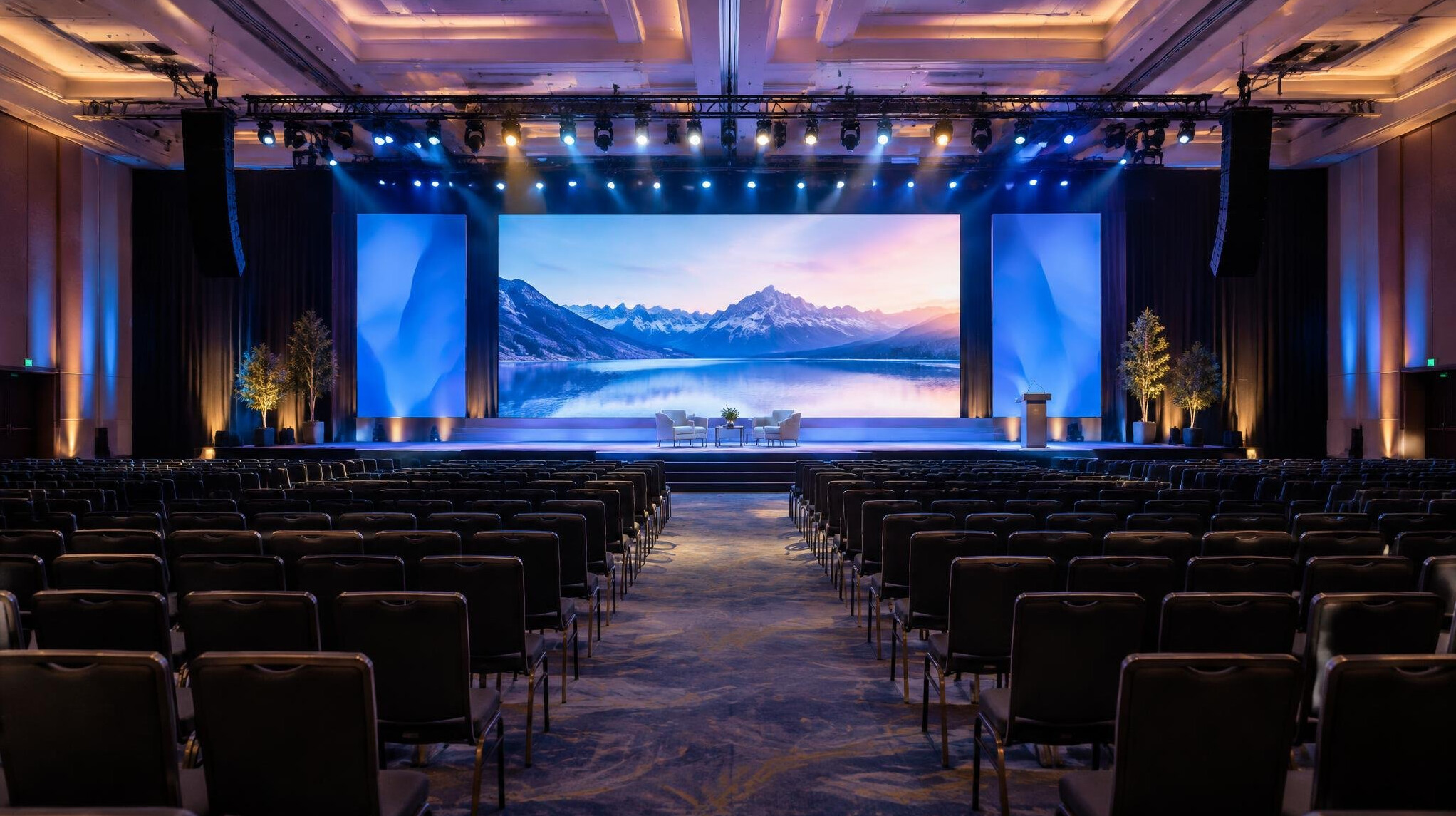 Event hall with audience facing a lit stage